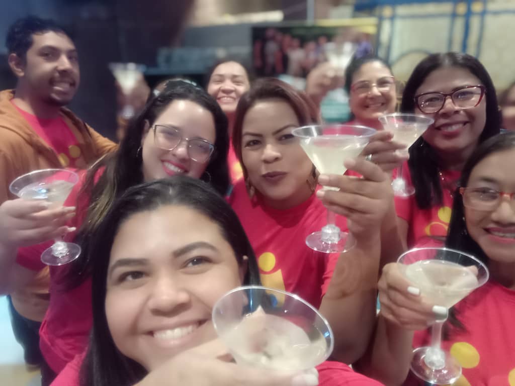 man wearing a black jacket, white shirt, blue jeans, and brown boots, playing a white electric guitar while sitting on an amp